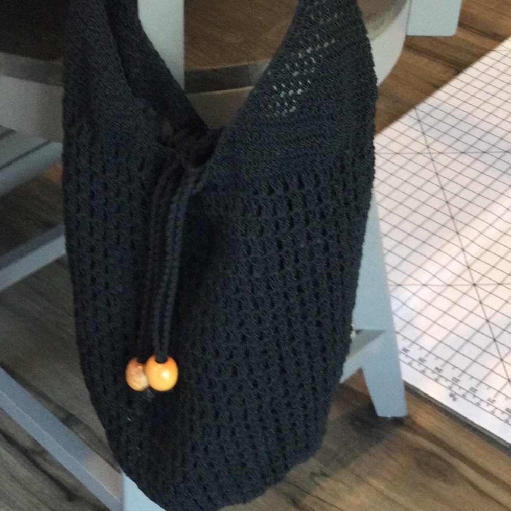 Black crochet like bucket style hobo bag